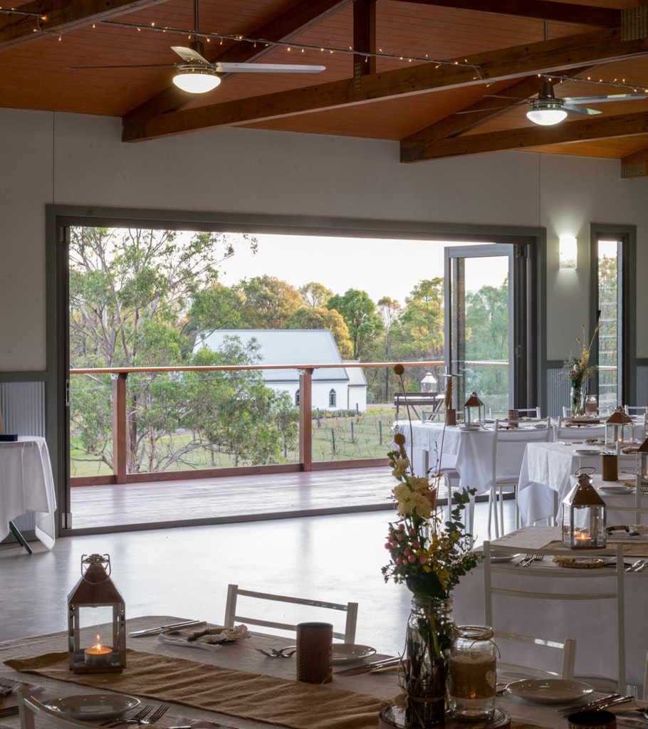 Wedding reception centre with doors open looking outside to a chapel.